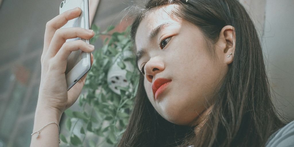 woman holding smartphone outside